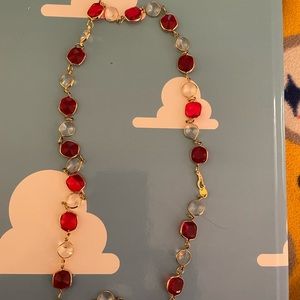 Gold tones custom jewelry. With red and clear Jules